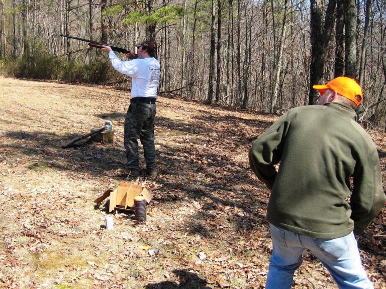Shooters at a clay target throwing station in the woods