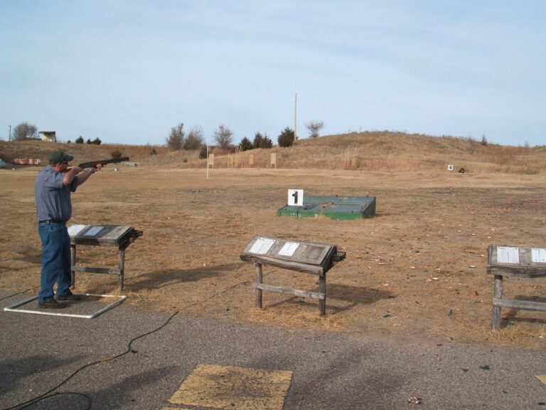 Shooter at a station on an open sporting clays field