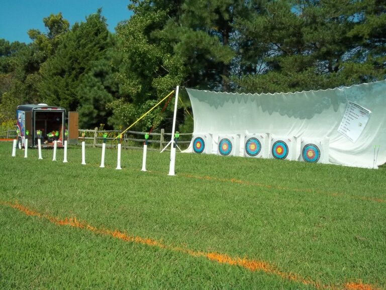 Archery range with target faces set against a backstop net in a park