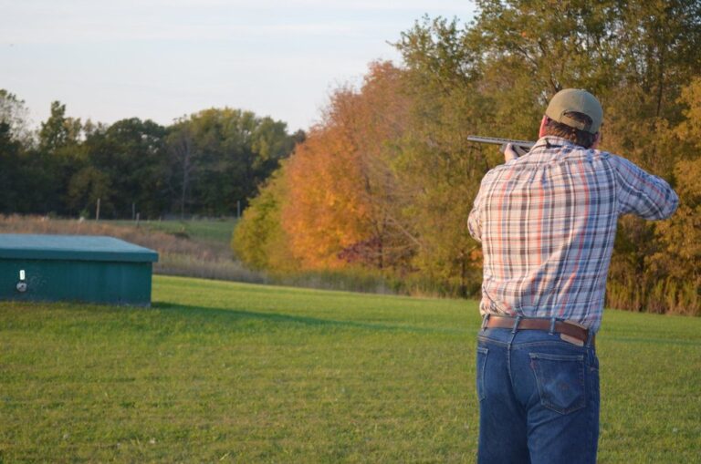 Shotgun shooter at a clay target field in autumn